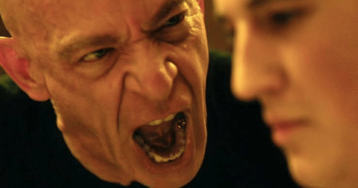 Best Whiplash quotes scene with Andrew Neiman playing drums in yellow lighting