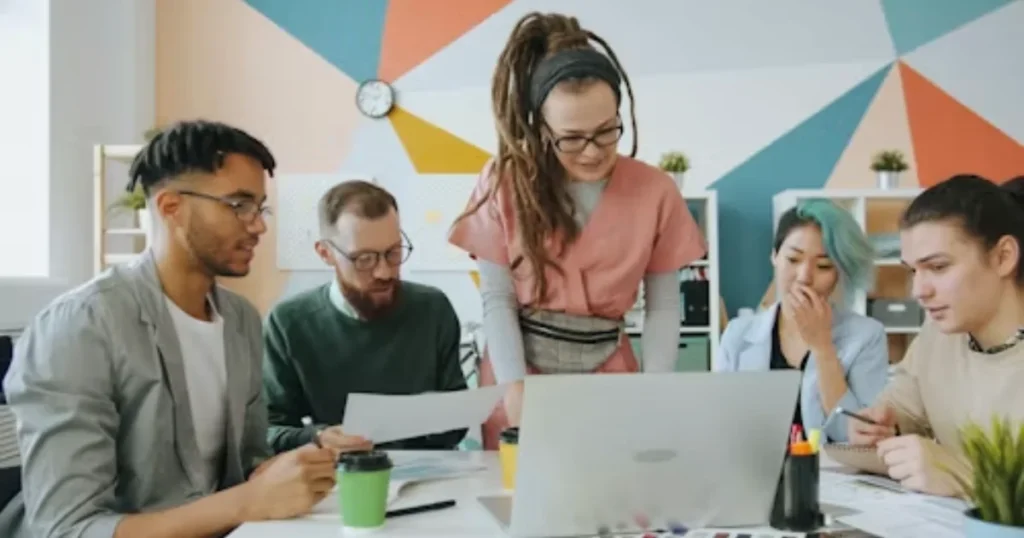 Colleagues collaborating around a table in a bright professional workspace
