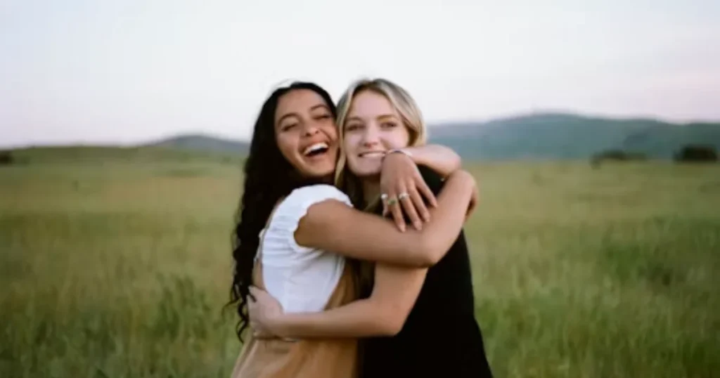 Sisters talking and laughing together outside