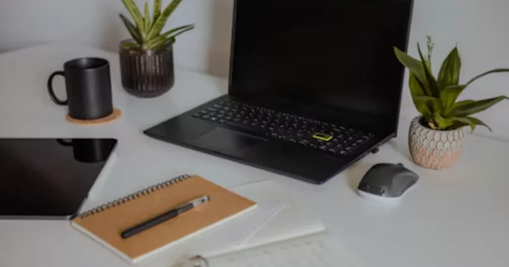 Organized desk with a notebook and pen representing focused work and achievement
