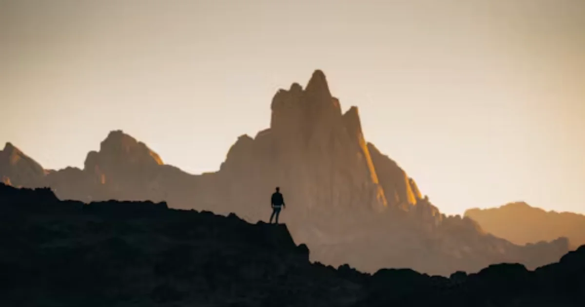 Inspirational sunrise over a mountain path representing motivation and personal growth