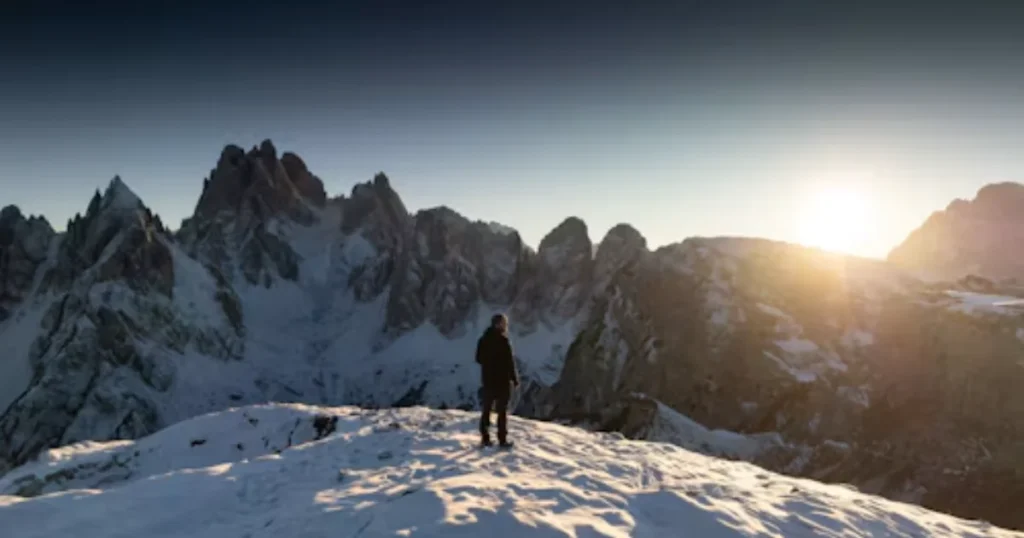 Person walking toward a mountain summit in the morning light