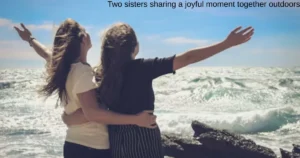 Two sisters sharing a joyful moment together outdoors