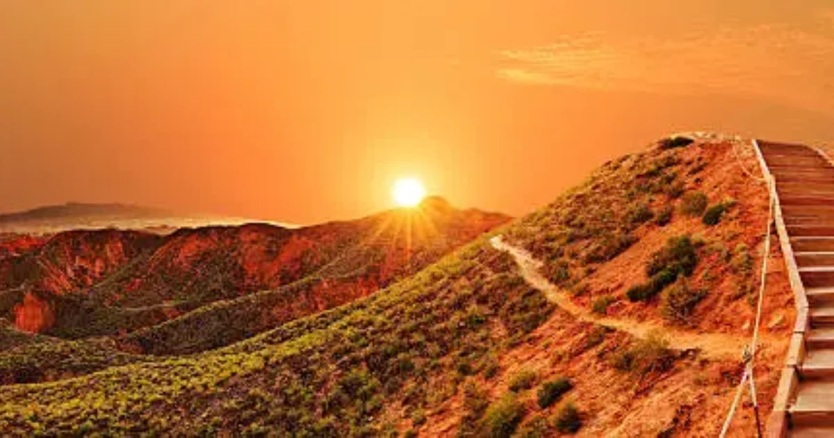 Sunrise over a mountain path symbolizing ambition, achievement, and personal growth