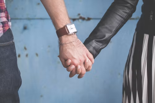 Two hands holding each other gently, symbolizing the slow process of rebuilding trust in a relationship