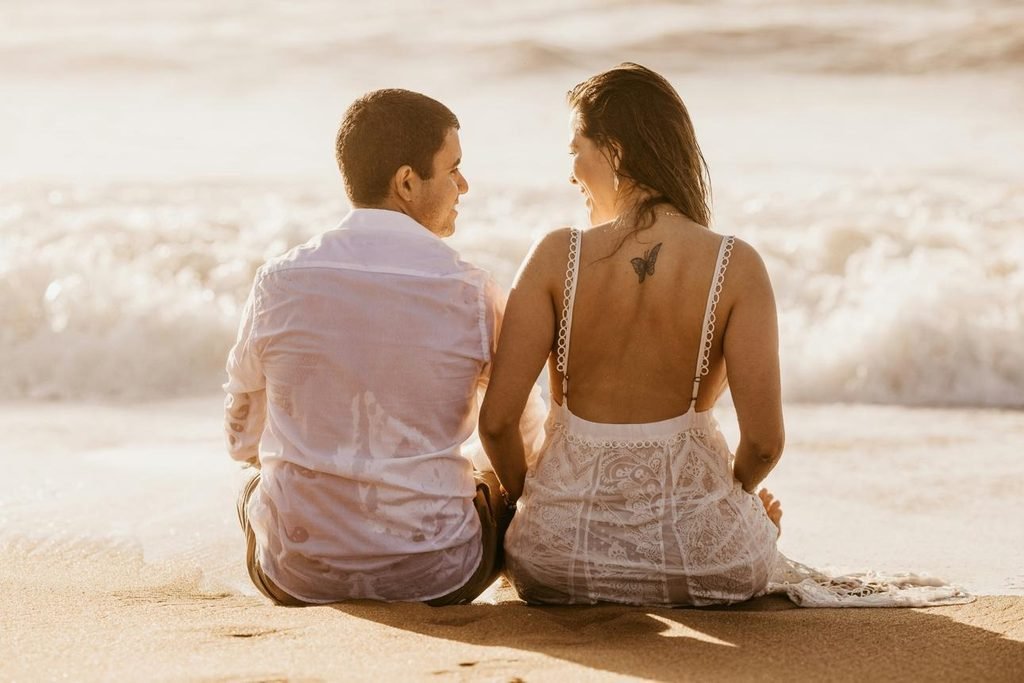 Couple holding hands at sunset symbolizing love, reassurance, and rebuilding trust.