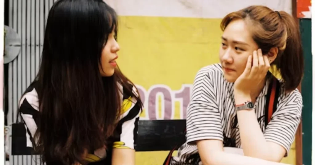 Two friends talking together during a meaningful outdoor conversation in friendship quotes